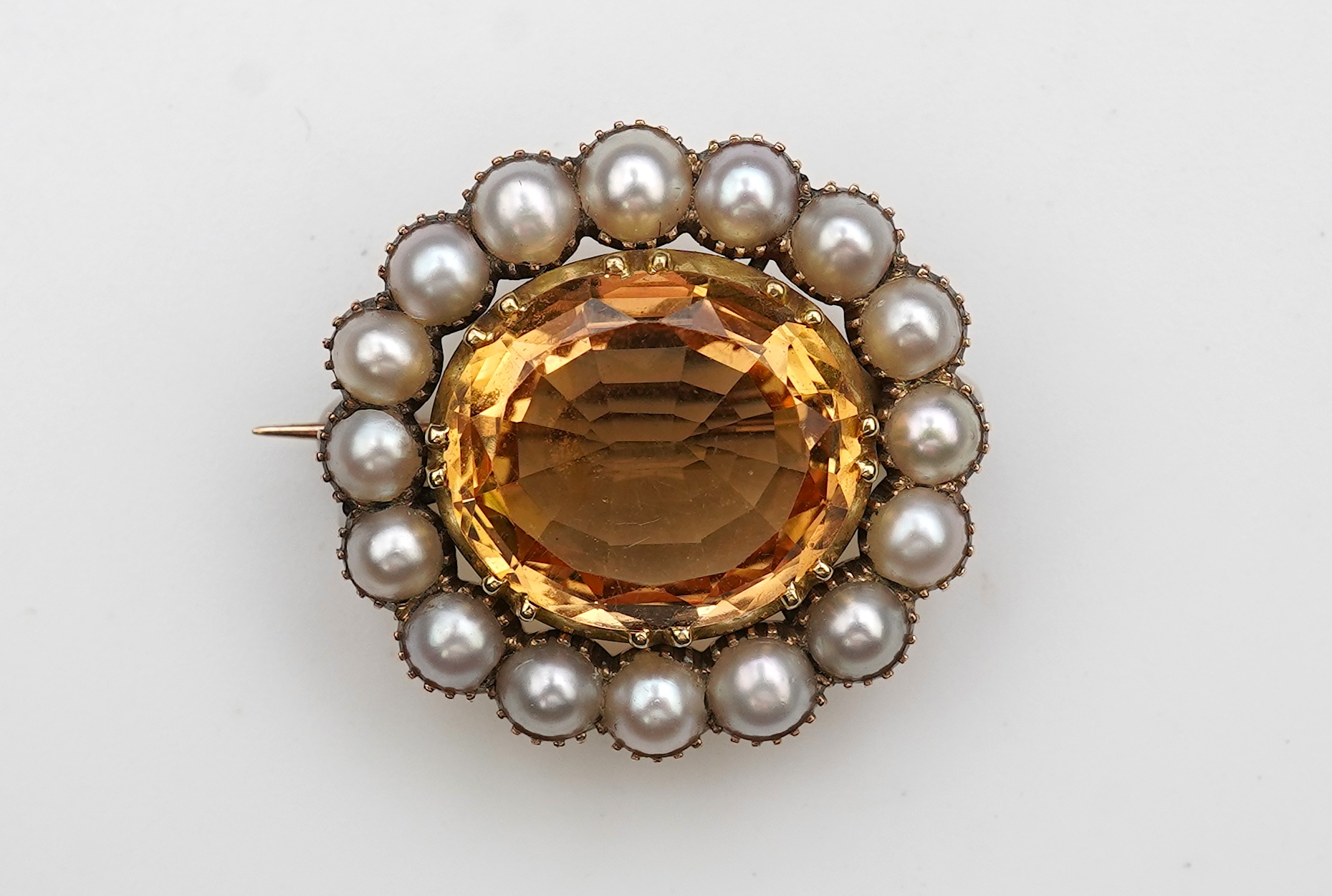 A Victorian topaz and pearl brooch, late 19th century
